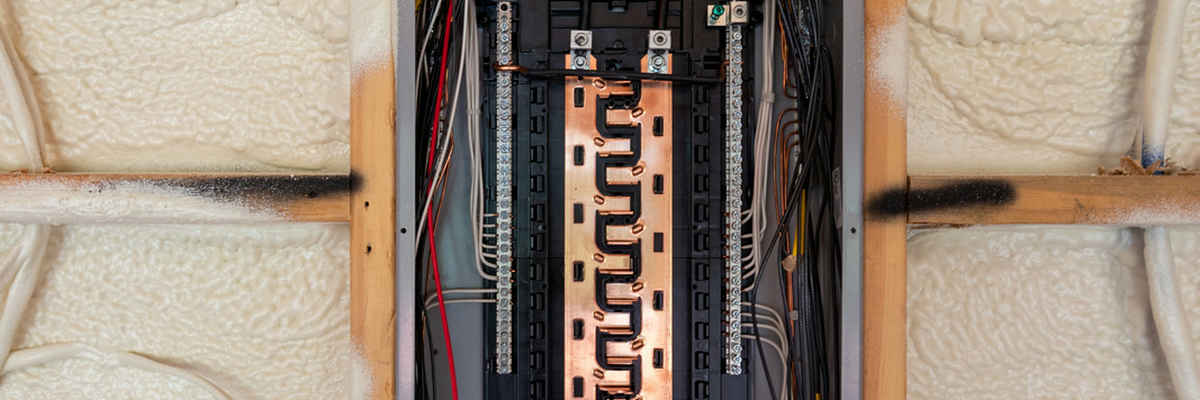 Electrical circuit breaker panel and spray foam insulation